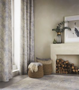 a pair of curtains in an interiors feature room set with fireplace and basket 